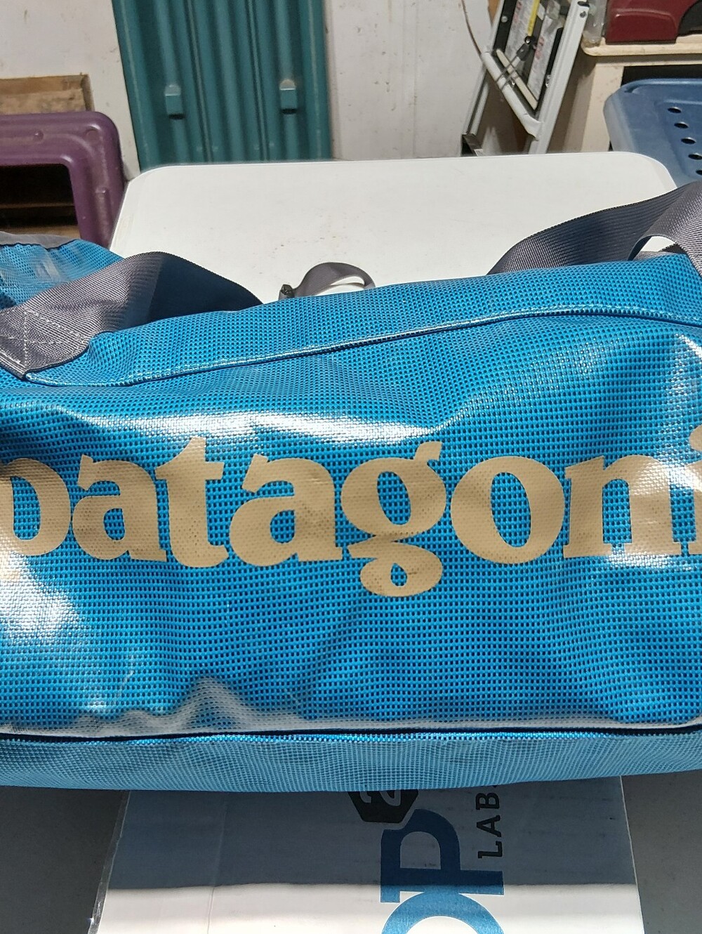 Patagonia Teal Blue Duffel Bag with Gold Logo